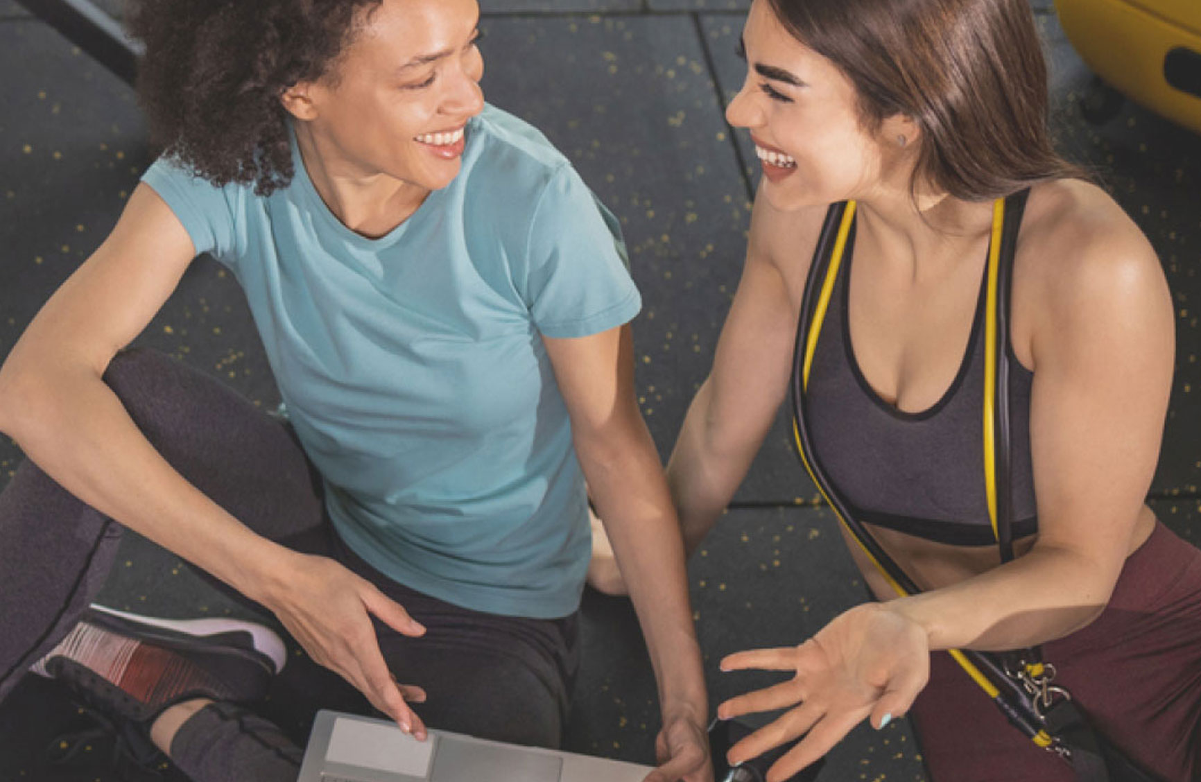 two girls talking at a fitness studio