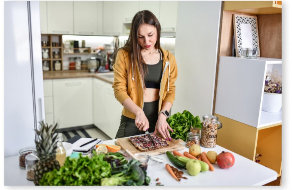 A lady in gym wear doing meal preparation.