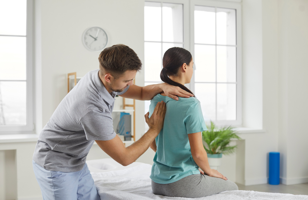 Chiropractor examining a clients spine